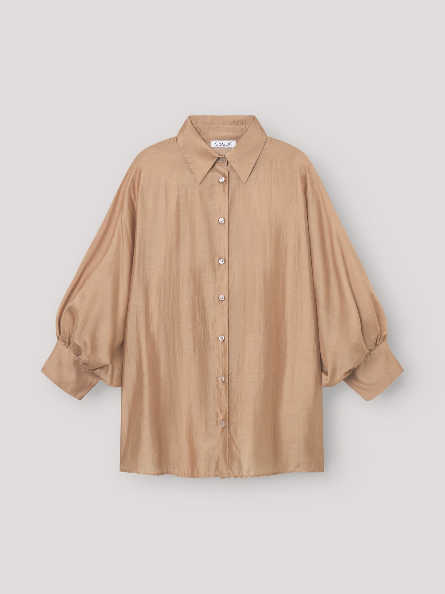 Eine locker sitzende, goldene Bluse Antonia mit kurzen Ärmeln und Knöpfen auf der Vorderseite, die sich perfekt als Sommerbluse eignet und vor einem schlichten weißen Hintergrund präsentiert wird.