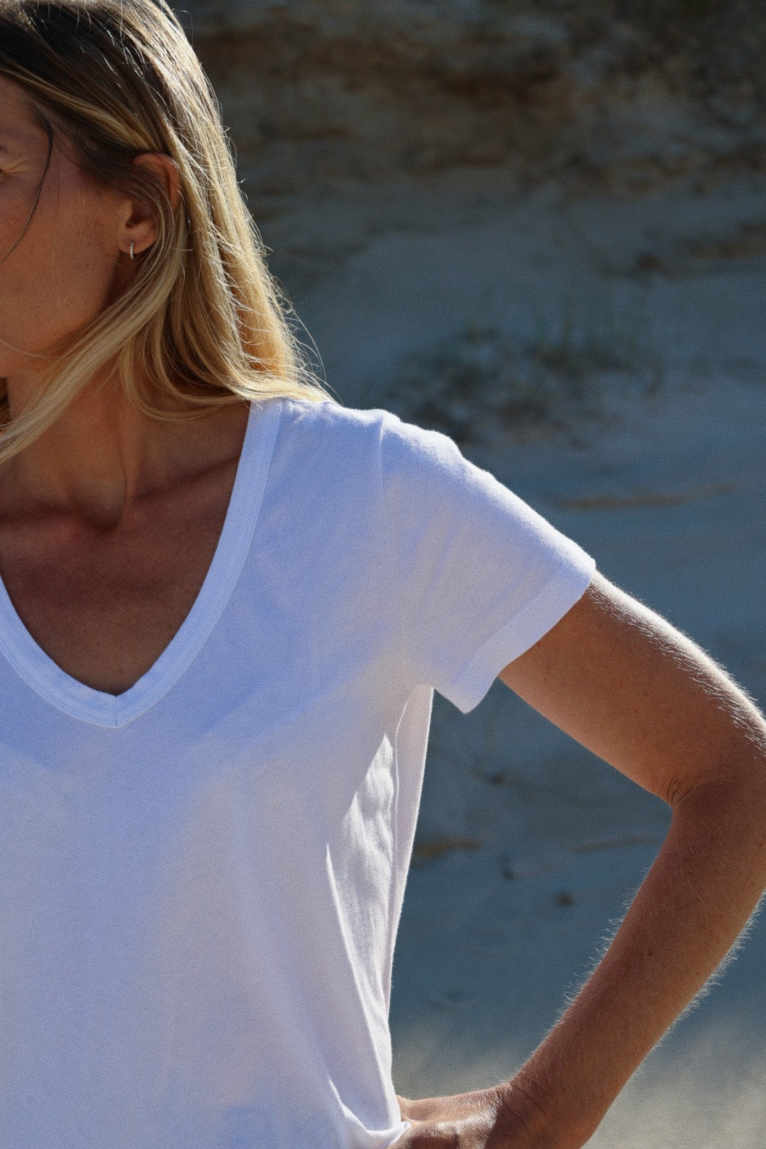 Eine Frau trägt das T-Shirt V-Neck weiß, hergestellt aus 100% Baumwolle.