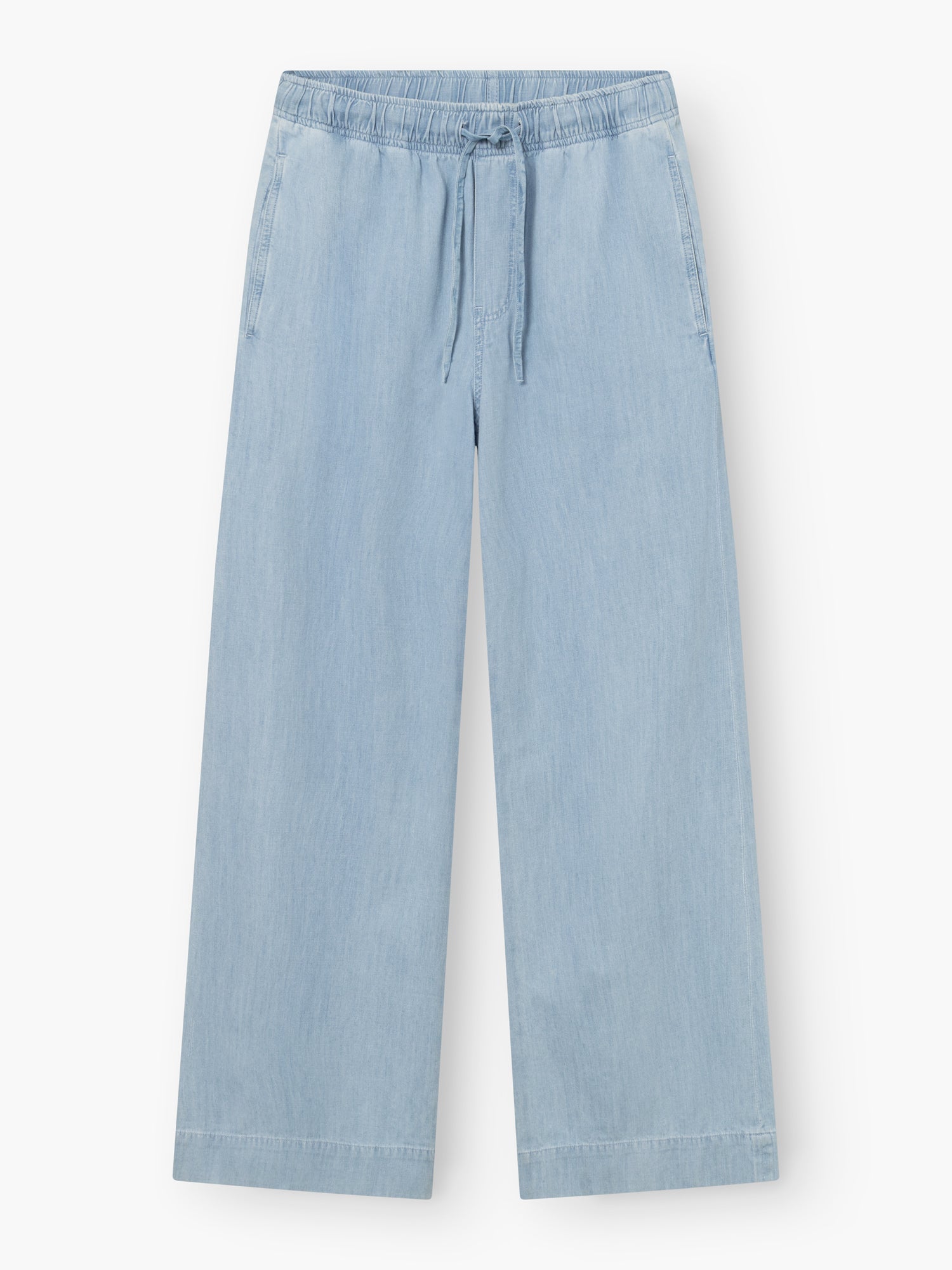 Die Anna Pants Light Denim ist eine hellblaue Jeanshose mit weitem Bein, elastischem Bund, Kordelzug, Seitentaschen und einer lockeren, knöchellangen Passform für lässigen Stil.