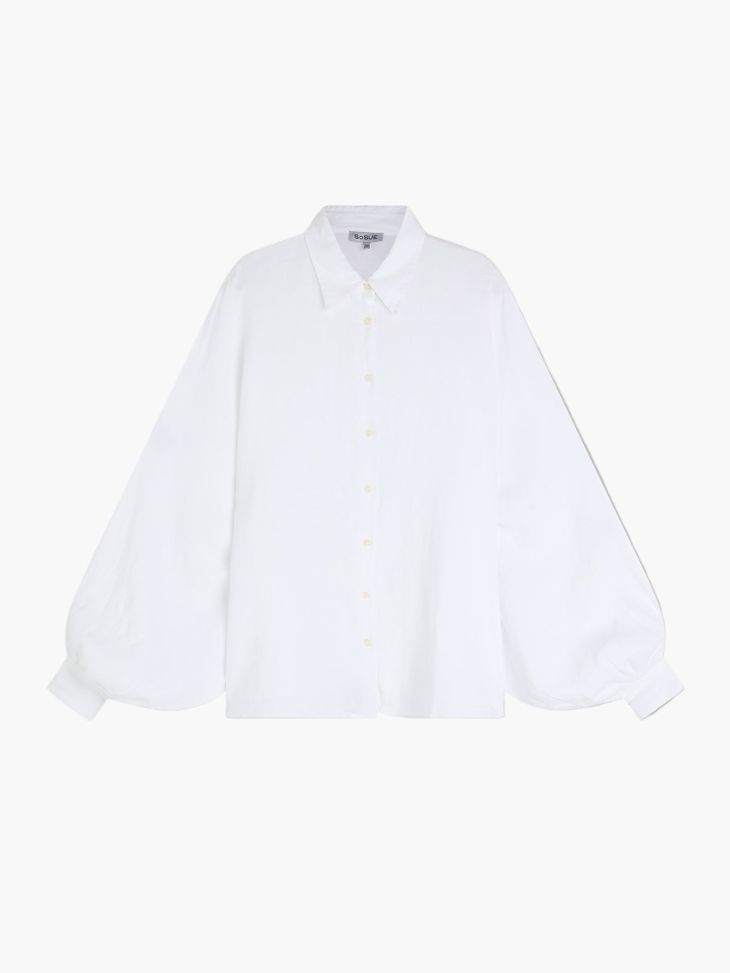 Die Bluse Antonia White zeichnet sich durch einen spitzen Kragen, weite Ballonärmel und eine übergroße Silhouette aus, die auf einem schlichten weißen Hintergrund gezeigt wird.