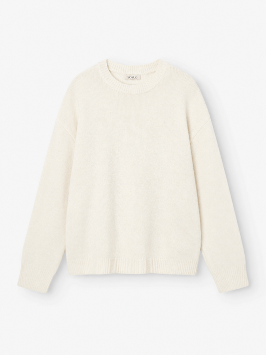 Ein schlichter, langärmeliger Pullover für Damen in Offwhite mit klassischem Rundhalsausschnitt wird flach auf einem weißen Hintergrund präsentiert, wodurch seine weiche Strickstruktur und der zeitlose Stil des Damenpullovers zur Geltung kommen.