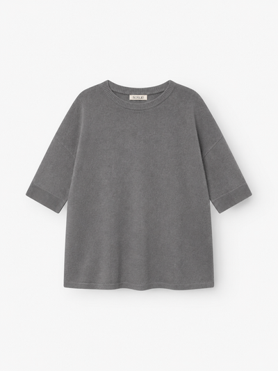 Ein graues Strick-T-Shirt „Aurora Anthra“ mit kurzen Ärmeln, lockerer Passform und rundem Ausschnitt, gefertigt aus weichem Strickstoff und flach auf weißem Hintergrund präsentiert.
