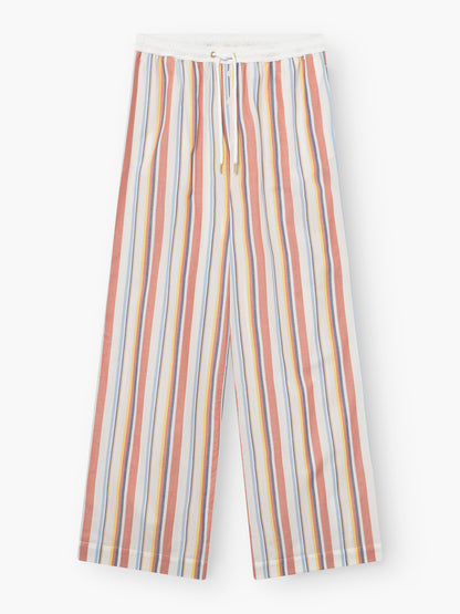 Hose New York: Locker sitzende Hose mit elastischem Bund und Kordelzug, mit vertikalen Streifen in Rot, Gelb, Blau und Orange auf weißem Grund.