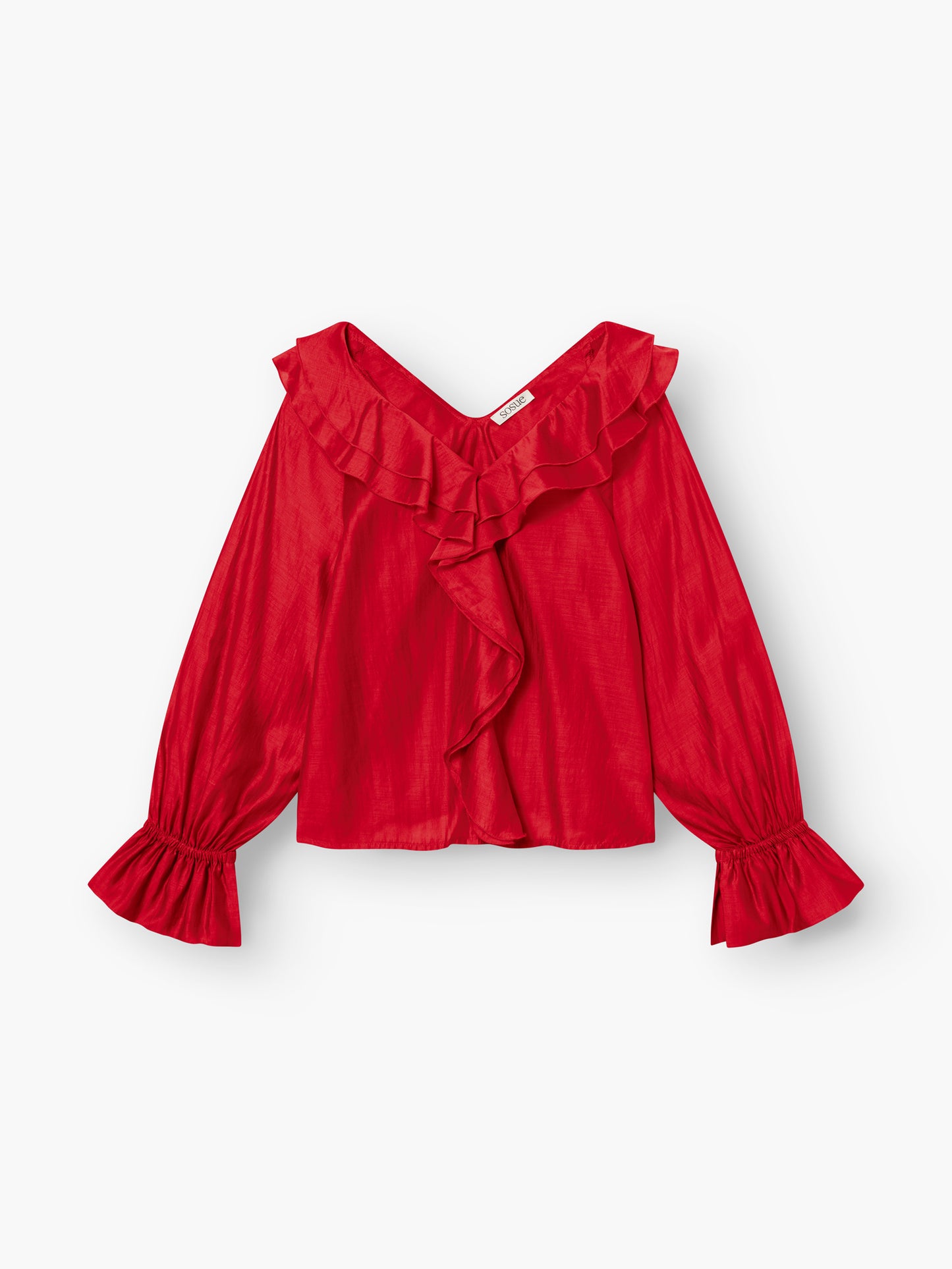 Das Ruffle Long Sleeve Red zeichnet sich durch Rüschenbesatz am V-Ausschnitt, auf der Vorderseite und an den Ärmeln aus. Es ist aus leichtem, leicht glänzendem Lyocell gefertigt und damit eine modische und nachhaltige Wahl.